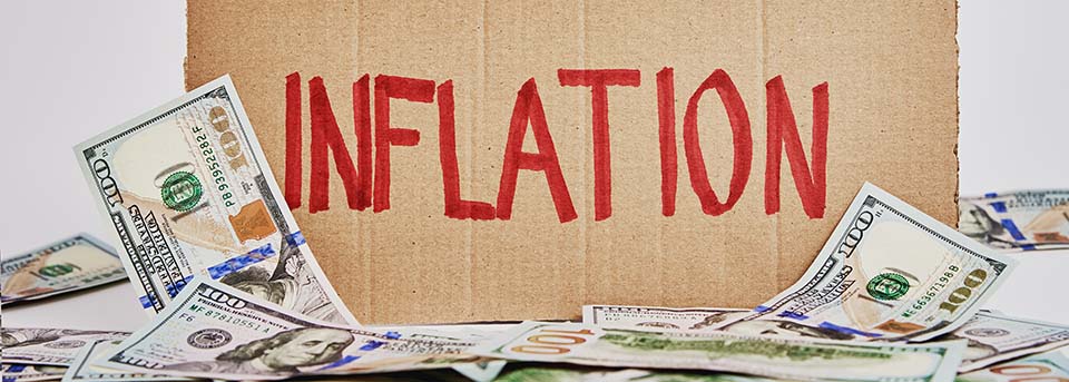 World economic crisis and inflation concept, Cardboard sheet with word inflation and us dollar banknotes, Rising prices for consumer goods and services. Impact of Inflation on Family Finances